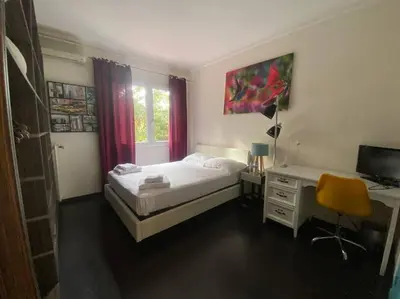 a bedroom with a bed and a desk with a computer at Superb Villa, heated swimming pool, central location, secluded gardens in Cannes