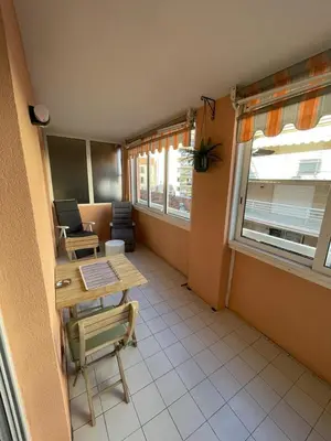 an empty room with a table and a window at Appartement proche mer in Cannes