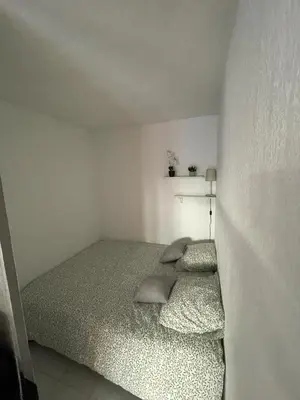 a bedroom with a bed with two pillows on it at Appartement proche mer in Cannes