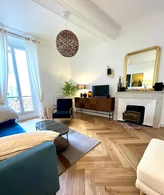 a living room with a blue couch and a fireplace at Apartment Center of Cannes, Croisette in Cannes