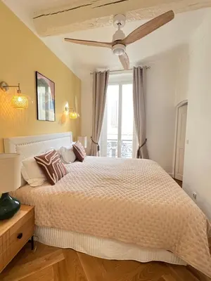 a bedroom with a large bed and a window at Apartment Center of Cannes, Croisette in Cannes