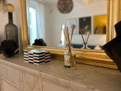 a bottle on a dresser in front of a mirror at Apartment Center of Cannes, Croisette in Cannes