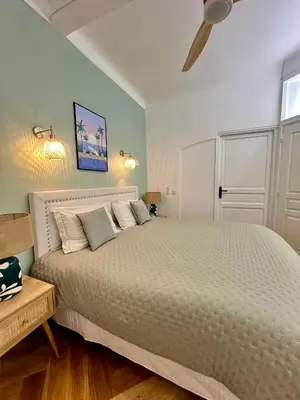 a bedroom with a bed and a ceiling fan at Apartment Center of Cannes, Croisette in Cannes