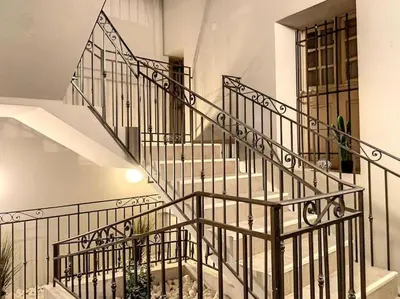 a staircase in a white building with a stair case at Apartment Center of Cannes, Croisette in Cannes