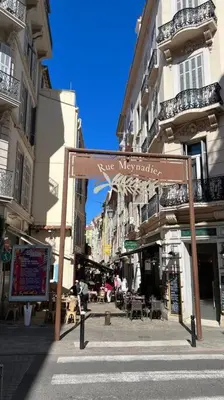 a sign on a street in a city with buildings at Apartment Center of Cannes, Croisette in Cannes