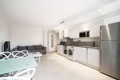 a kitchen and living room with a stainless steel refrigerator at Magnifique appartement T3 centre Cannes in Cannes