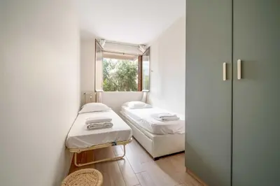 a small room with two beds and a window at Magnifique appartement T3 centre Cannes in Cannes