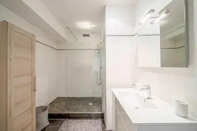 a white bathroom with a sink and a shower at Magnifique appartement T3 centre Cannes in Cannes
