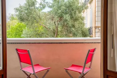 two red chairs sitting in front of a window at Magnifique appartement T3 centre Cannes in Cannes