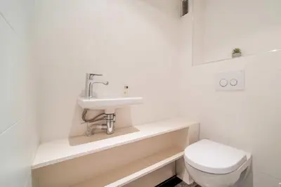 a white bathroom with a sink and a toilet at Magnifique appartement T3 centre Cannes in Cannes