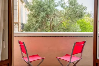 two red chairs sitting in front of a window at Magnifique appartement T3 centre Cannes in Cannes