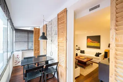 a dining room and living room with a table and chairs at GAB1 - 3 pièces au cœur du centre ville in Cannes