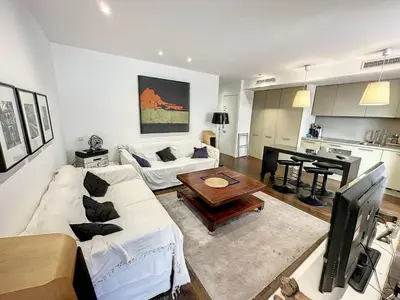 a living room with a white couch and a table at GAB1 - 3 pièces au cœur du centre ville in Cannes