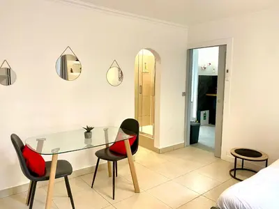 a dining room with a glass table and two chairs at Grand Studio centre de Cannes in Cannes