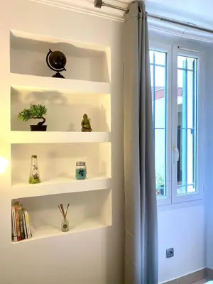 a room with white shelves and a window at Grand Studio centre de Cannes in Cannes