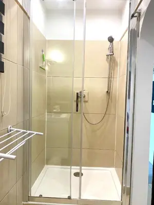 a shower with a glass door in a bathroom at Grand Studio centre de Cannes in Cannes