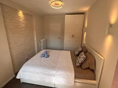 a bedroom with a white bed with pillows on it at Les Arènes - Cannes centre, Charmant 2 pièces récemment rénové de 45 m2 avec sa terrasse de 10 m2 in Cannes
