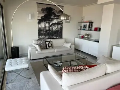 a living room with two white couches and a table at Penthouse Cannes 100m2 avec 2 suites et terrasse 80m2 in Cannes