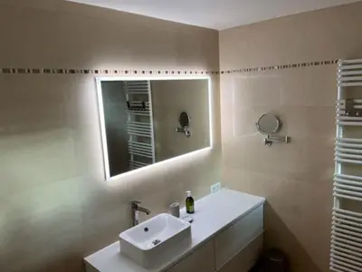 a bathroom with a sink and a mirror at Penthouse Cannes 100m2 avec 2 suites et terrasse 80m2 in Cannes
