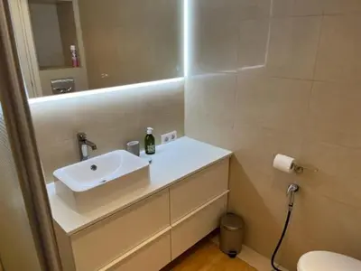 a bathroom with a white sink and a mirror at Penthouse Cannes 100m2 avec 2 suites et terrasse 80m2 in Cannes
