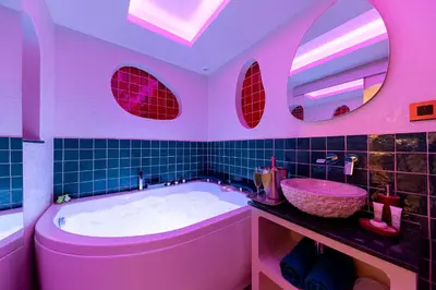 a pink bathroom with a tub and a sink at Les Jardins de Marrakech Super centre in Cannes
