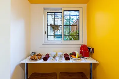 a table with fruit on it next to a window at Les Jardins de Marrakech Super centre in Cannes