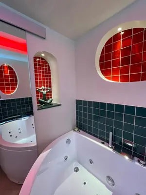 a bathroom with a bath tub and a sink at Les Jardins de Marrakech Super centre in Cannes