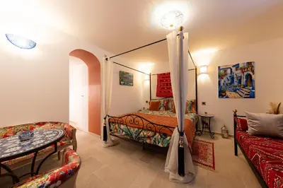 a bedroom with a bed and a couch at Les Jardins de Marrakech Super centre in Cannes