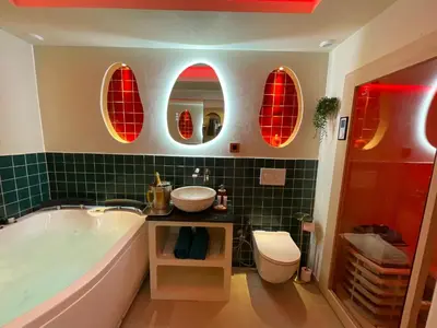 a bathroom with a tub and a toilet and three mirrors at Les Jardins de Marrakech Super centre in Cannes