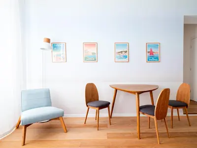 a dining room with a table and four chairs at Appartements proche Croisette, Casino, plages, centre ville et Gare in Cannes