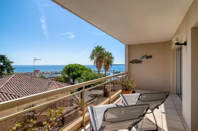 a balcony with chairs and a view of the ocean at Bright apartment with sea view - Palm Beach in Cannes