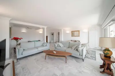a living room with two white couches and a table at Bright apartment with sea view - Palm Beach in Cannes