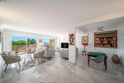 a living room with a couch and a table at Bright apartment with sea view - Palm Beach in Cannes