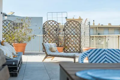 a patio with two chairs and a fence at 2-Br Rooftop in Palm Beach 2-min walk to beaches in Cannes