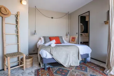 a bedroom with a bed and a chair at 2-Br Rooftop in Palm Beach 2-min walk to beaches in Cannes