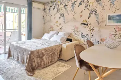 a bedroom with a bed and a table with chairs at AzurAppart 3-rooms Cannes Carnot in Cannes