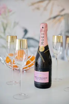 a bottle of champagne sitting on a table with wine glasses at AzurAppart 3-rooms Cannes Carnot in Cannes