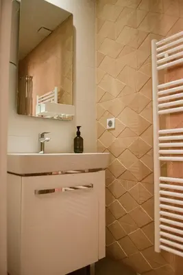 a bathroom with a sink and a mirror at AzurAppart 3-rooms Cannes Carnot in Cannes