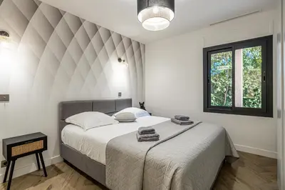 a white bedroom with a large bed with towels on it at Luxurious Villa with heated pool 6BR-12p - Cannes in Cannes