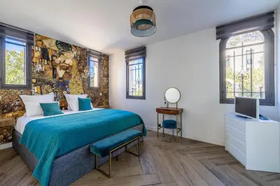 a bedroom with a bed with a blue bedspread at Luxurious Villa with heated pool 6BR-12p - Cannes in Cannes