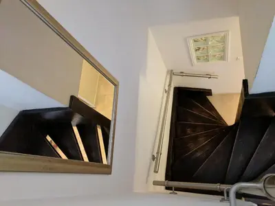a mirror on a wall next to a stairway at Citilet 4 Duplex, funky with large terrace in Cannes