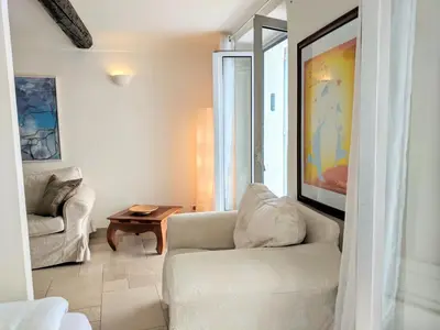 a living room with a white couch and a table at Citilet 4 Duplex, funky with large terrace in Cannes