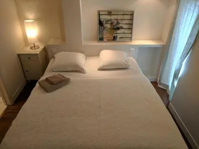 a bedroom with a bed with two pillows at Citilet 4 Duplex, funky with large terrace in Cannes