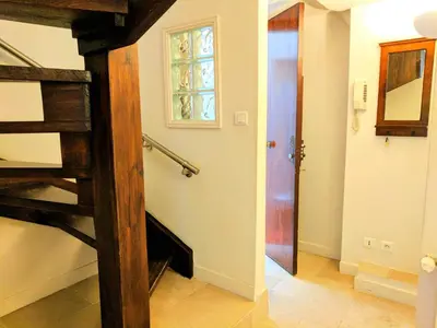 a hallway with a spiral staircase and a window at Citilet 4 Duplex, funky with large terrace in Cannes