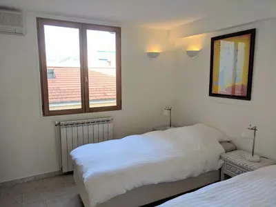 two beds in a room with two windows at Citilet 6 Bright, open-plan with large terrace in Cannes