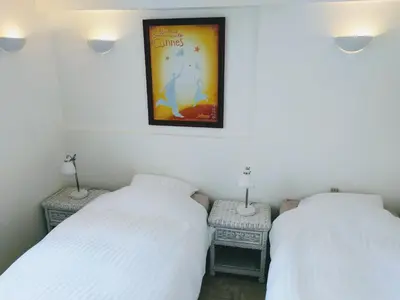 two beds in a room with a picture on the wall at Citilet 6 Bright, open-plan with large terrace in Cannes