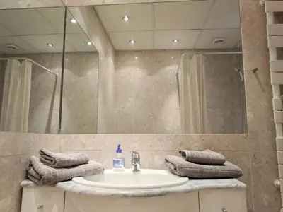 a bathroom with a sink and a mirror and towels at Citilet 6 Bright, open-plan with large terrace in Cannes