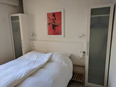 a bedroom with a bed and a picture on the wall at Citilet 6 Bright, open-plan with large terrace in Cannes