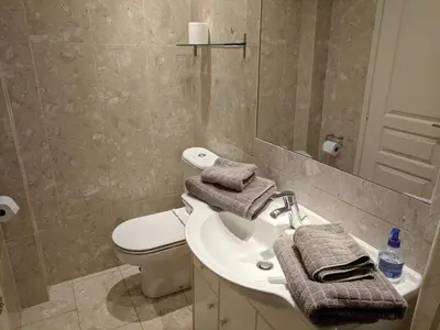 a bathroom with a sink and a toilet and a mirror at Citilet 6 Bright, open-plan with large terrace in Cannes