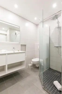 a bathroom with a shower and a sink and a toilet at Palm Beach 3 chambres in Cannes